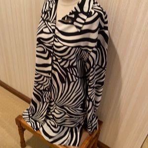 Blouse runs long, can be  worn as a tunic with leggings. Cuffed sleeves.